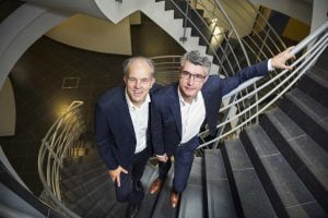 Jacques Parlong, former CEO of N-SIDE, and Philippe Chevalier, founder and current CEO of N-SIDE, standing on stairs.